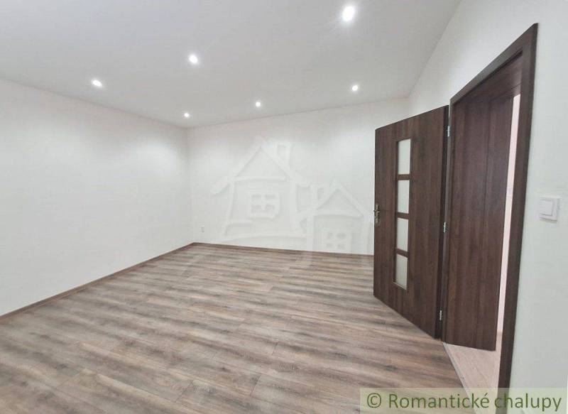 Room with a wooden floor and doors in a family house.