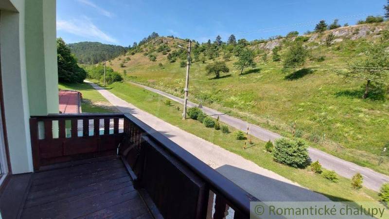 The view from the balcony of a family house in Dobrá Voda to the green landscape and the road.