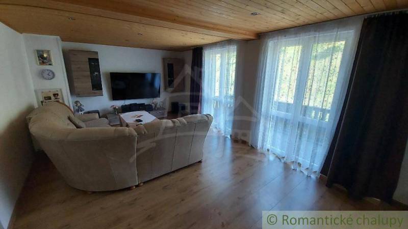 Living room in a family house with a large TV and a comfortable sofa.