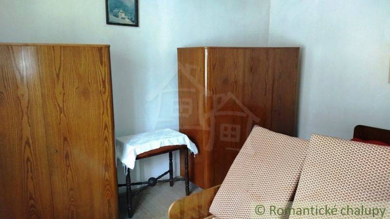 Wooden cabinets and a sofa in the room of a family house.