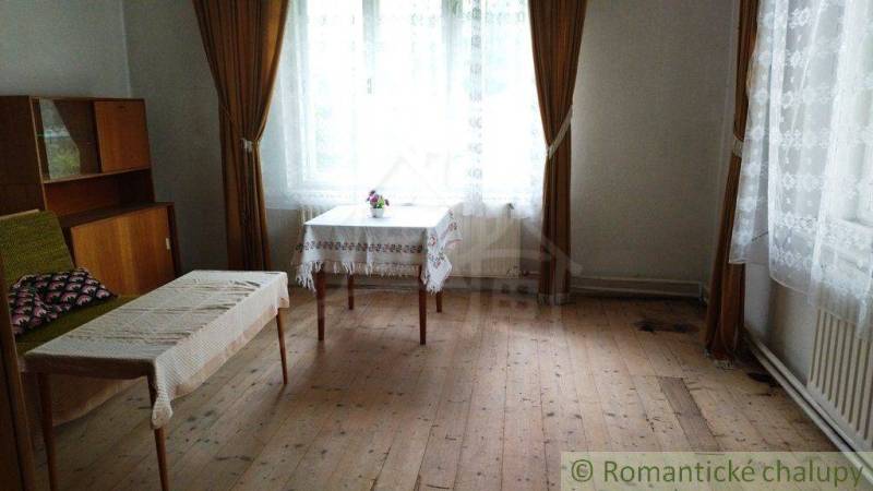 Living room of a family house with antique furniture and wooden flooring.