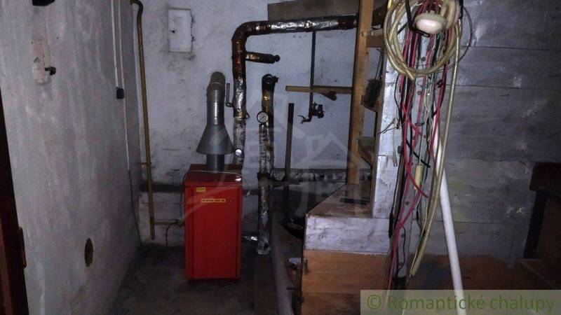 The basement in the family house contains a boiler and pipes.