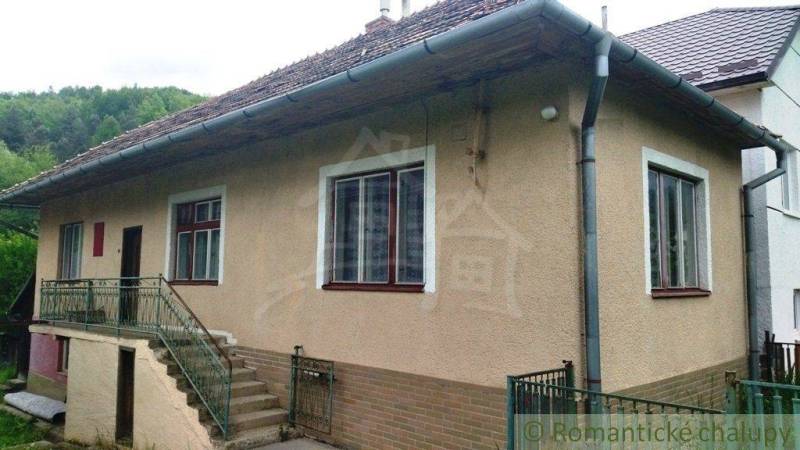 A family house in Fričovce surrounded by greenery with stairs and a veranda.