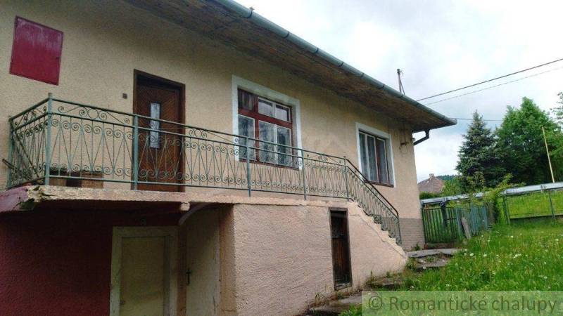 A family house in Fričovce with an external staircase and a garden.