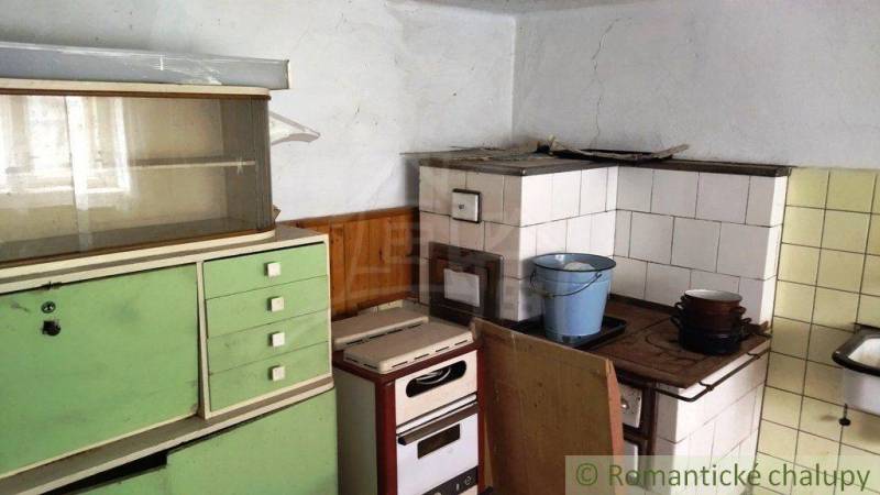 A kitchen with a traditional sideboard and stove in a family house, retro style.