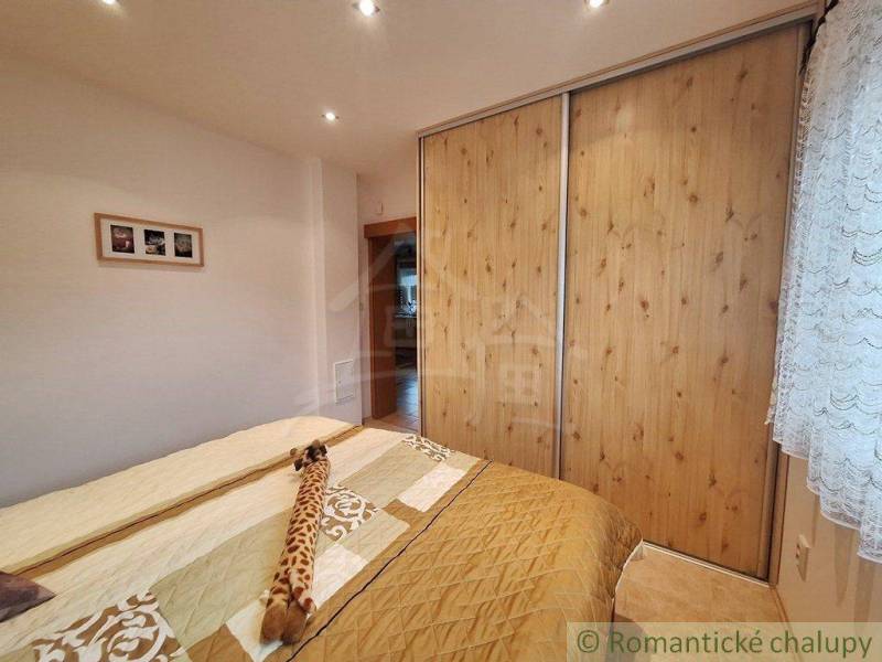 A bedroom in a family house with a bed and built-in wardrobes.