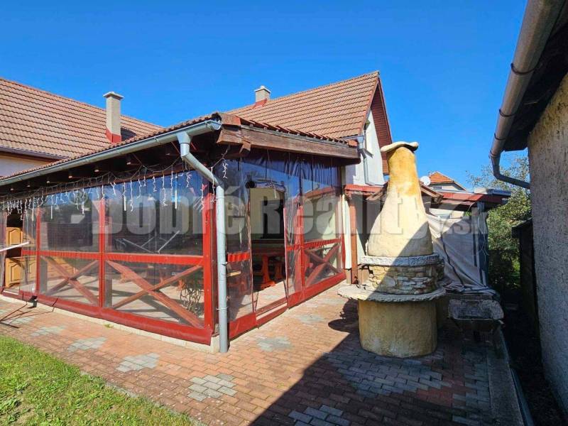 A family house in Malá Lehota with a terrace and a brick grill in the yard.