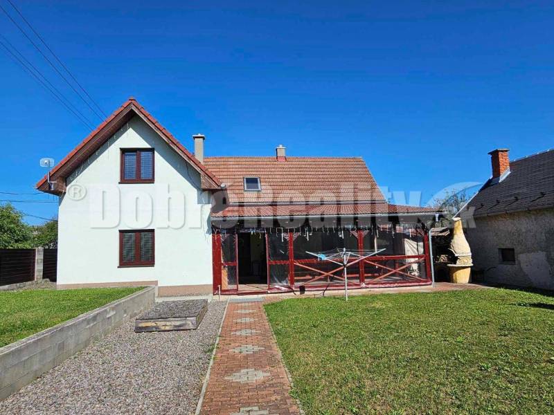 A family house in Malá Lehota with a gable roof and a landscaped garden.