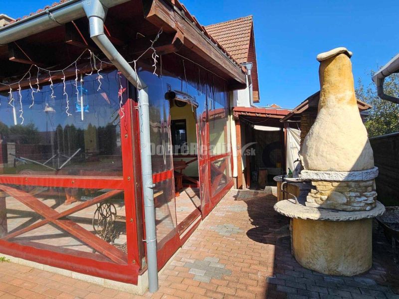 A family house in Malá Lehota with an outdoor fireplace and a glazed terrace, ideal for relaxation.