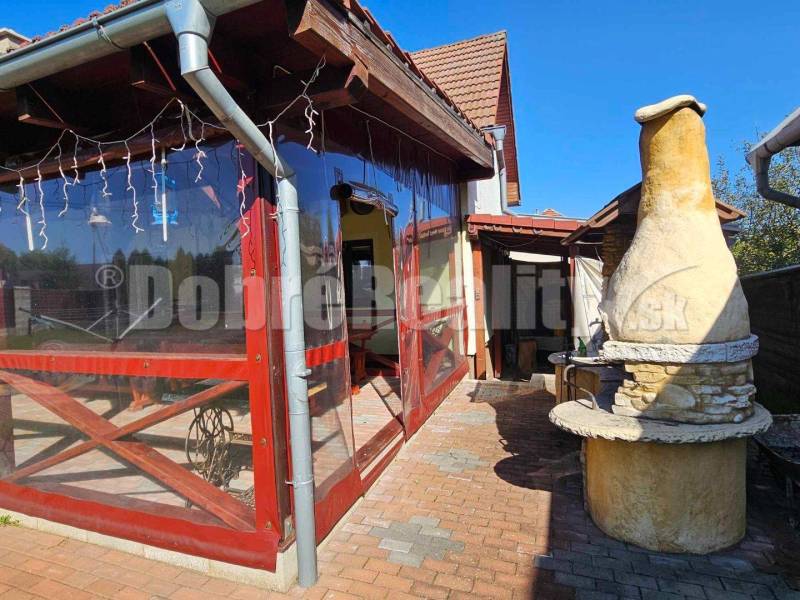 A family house in Malá Lehota with an outdoor brick grill and a covered terrace.