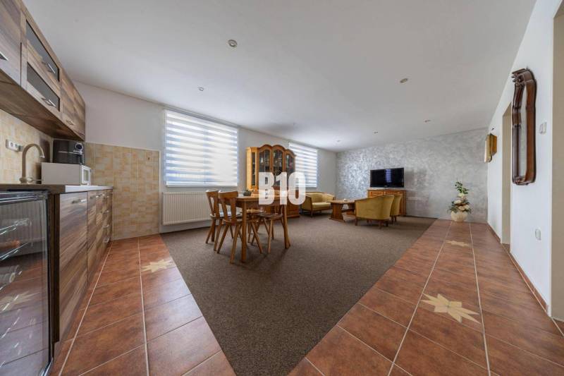Open kitchen with living room and dining table in a family house.