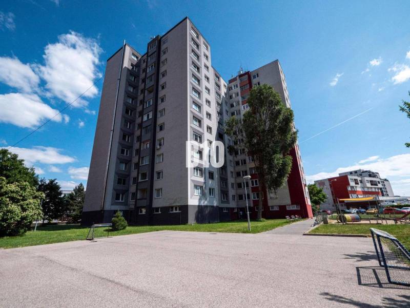 Apartment building in Bratislava on Andrusovova Street with surroundings and playground.