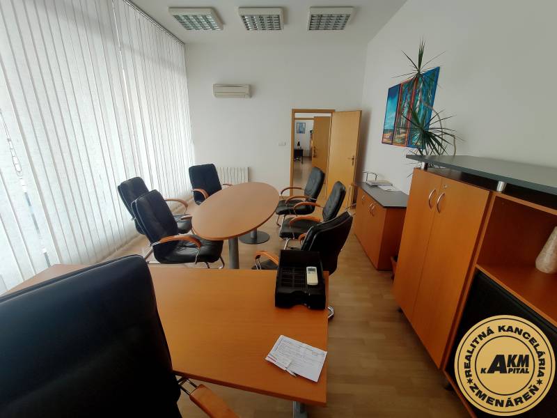 Offices furnished with round tables, chairs, and cabinets.