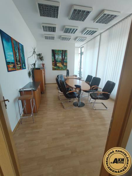 Conference room in the office with chairs, table, and artworks on the walls.