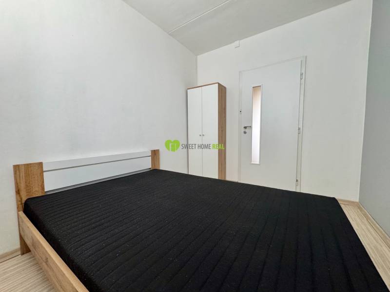 3-room apartment with a bed and a white wardrobe in the room.