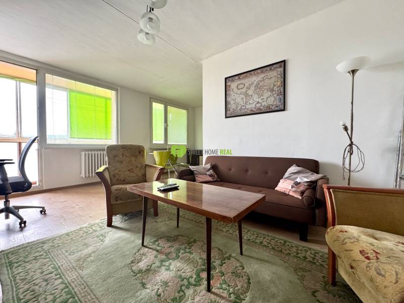 Living room in a 3-room apartment with a sofa, armchairs, and a table.