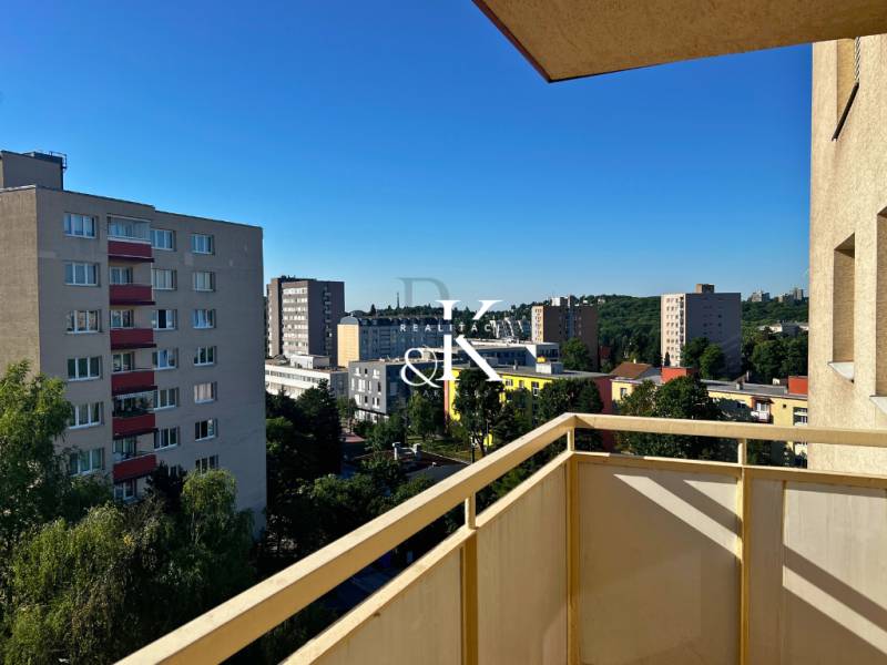 View from the balcony of an apartment building on Ladzianskeho in Bratislava - Vinohrady, surrounded by greenery.