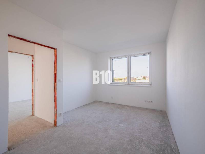 Empty room in a family house with white walls and a window.