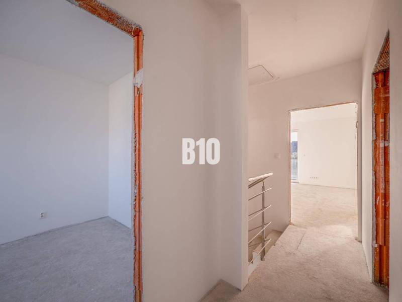 The interior of a family house with unfinished rooms and rough walls.