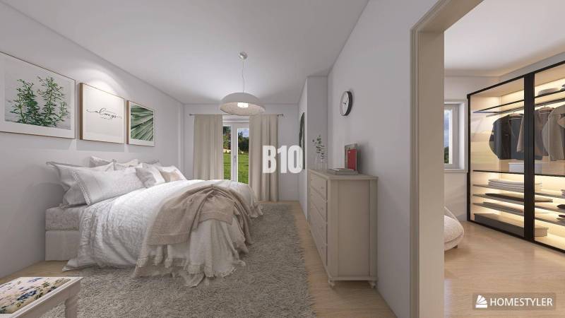 Bright bedroom with a large bed, curtains, and a wardrobe in a family house.