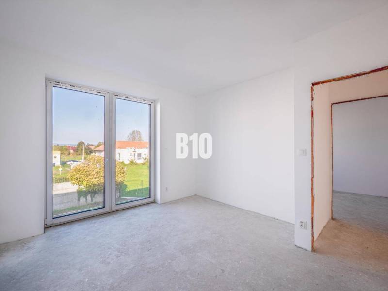 An empty room with a large window in a family house.