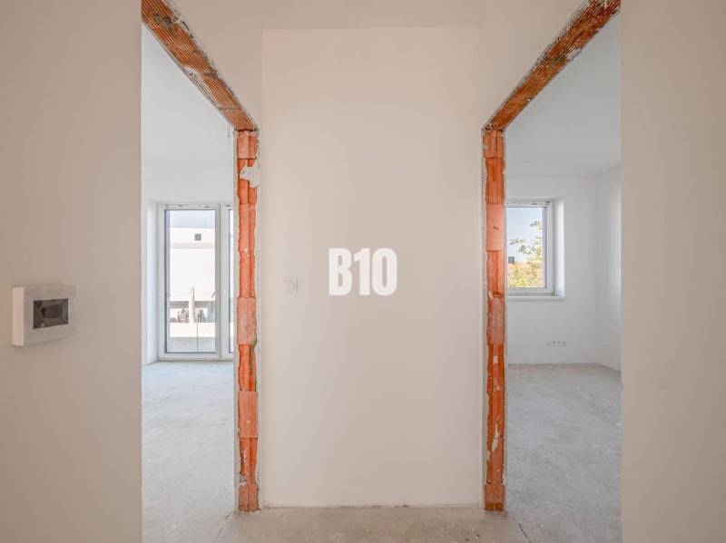 Interior photograph of two rooms in a family house with brick door frames.