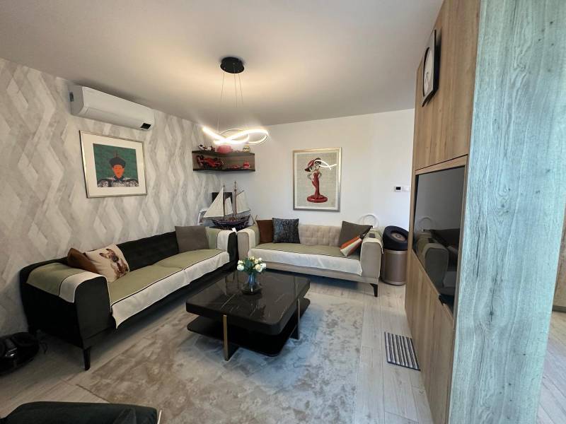 Living room in a family house with sofas, decorations, and paintings on the walls.