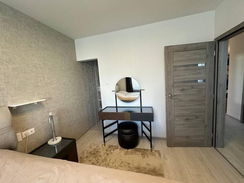 A bedroom in a family house with a dressing table and a mirror.