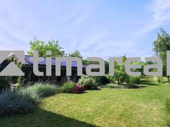 A garden at a 2-room apartment in Myjava with a lawn and trees in the background.
