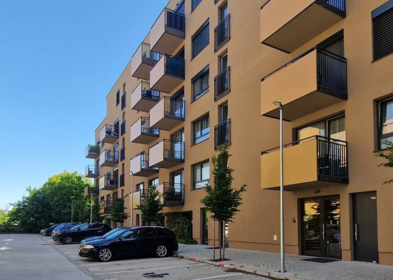 Apartment building on Sadova Street in Senica with parking and balconies for 2-room apartments.