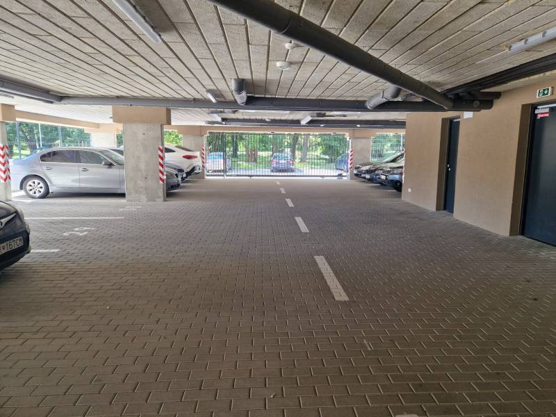 Underground parking spaces with cars near a 2-room apartment on Sadová Street in Senica.