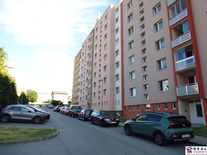Lomnická Street in Prešov with apartment buildings and parked cars, 3-room apartment.