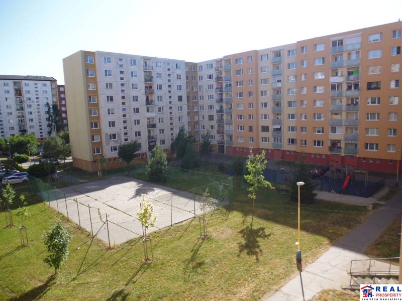 Housing estate in Prešov on Lomnická Street, with a children's playground and a sports area.