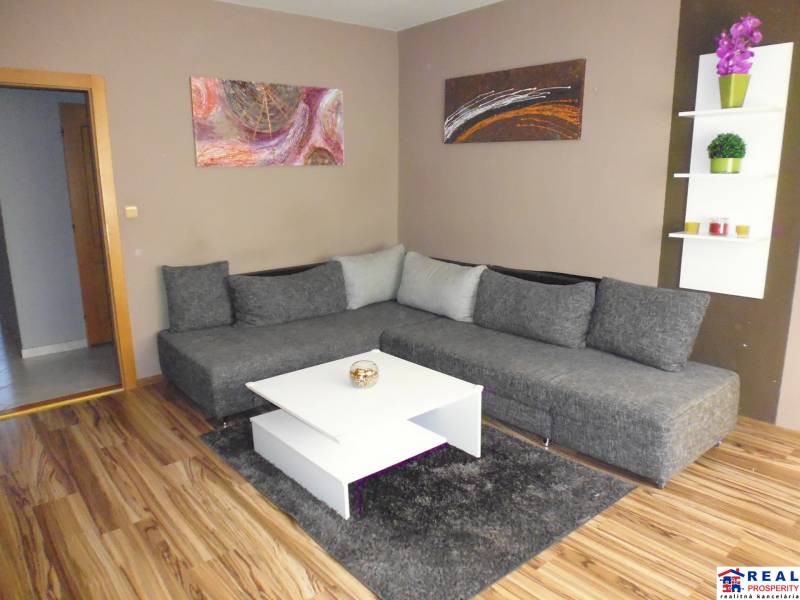 Living room in a 3-room apartment with a comfortable sofa and modern decor.