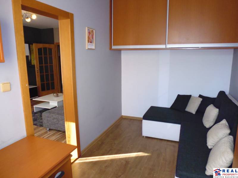 Living room with a sofa and built-in wardrobes in a 3-room apartment.