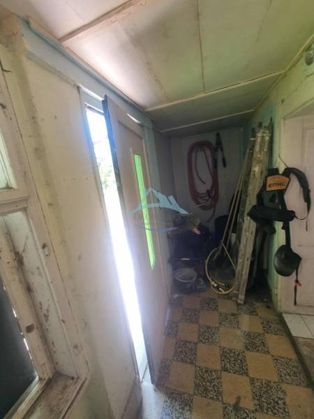 A narrow entrance hall in a family house with various tools and equipment.