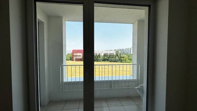 A balcony with a view of the surroundings in a 2-room apartment.