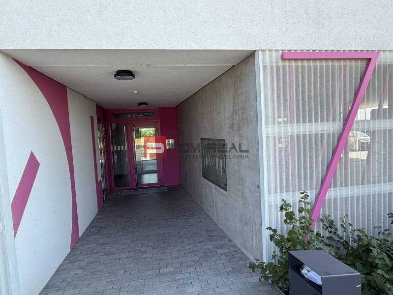 The entrance to the building on Labutia Street in Bratislava V with pink elements.