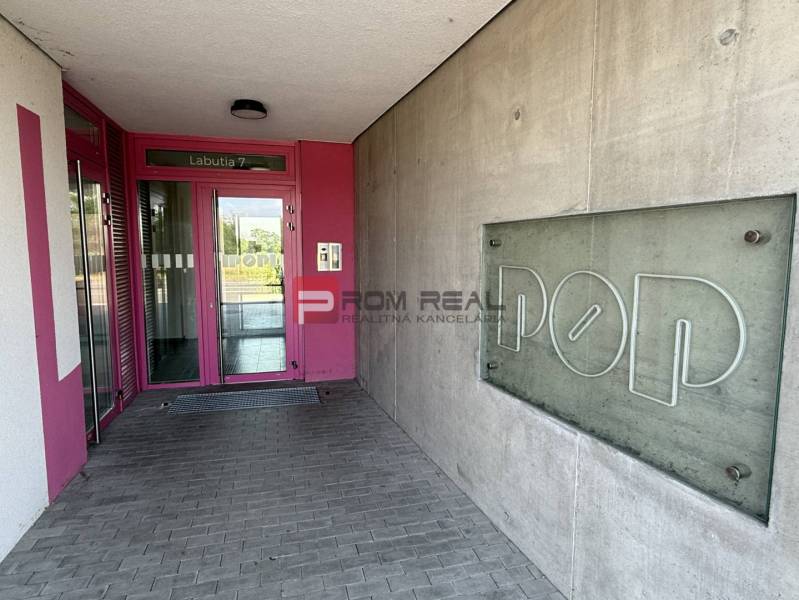 Entrance on Labutia Street in Bratislava V with the sign POP and pink doors.
