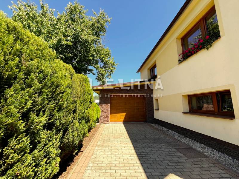 A family house in Kriváň on Kriváň Street with a garage and a landscaped garden.