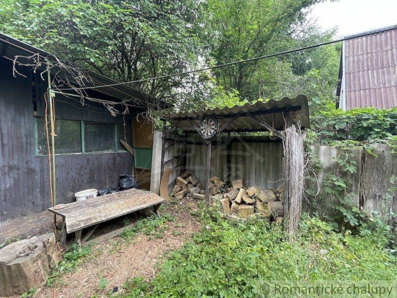 A family house in Branč with a woodshed, wood, a table, and a target in the yard.