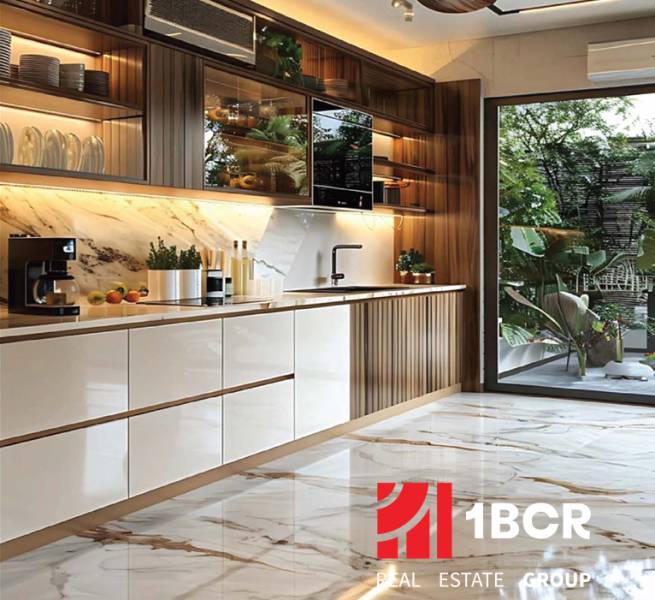 A kitchen in an apartment under construction with a marble floor and a view of the garden.