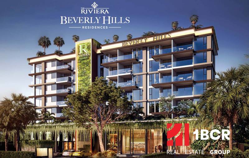 Apartment construction in Pattaya surrounded by greenery and palm trees, modern architectural design.