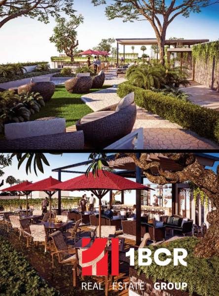 Garden and outdoor seating during apartment construction in Pattaya, surrounded by greenery.