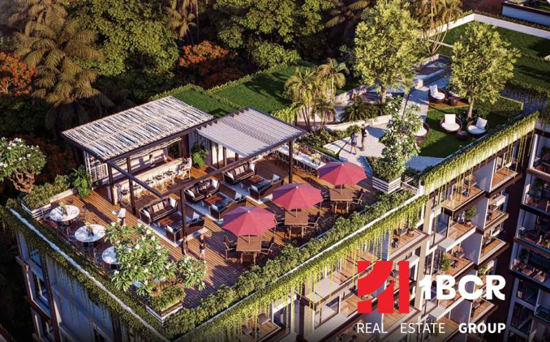 Rooftop garden with a terrace in a residential complex in Pattaya surrounded by greenery.
