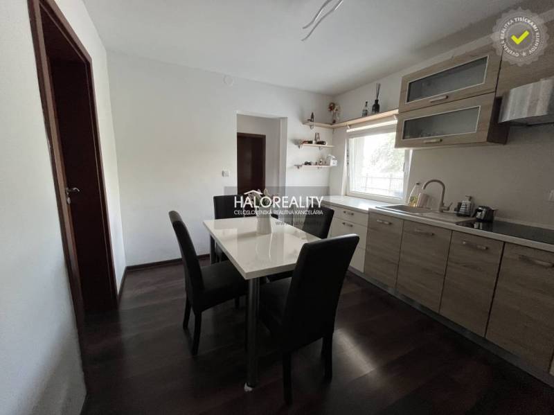 A dining room with wooden furniture and a dining table in a family house.
