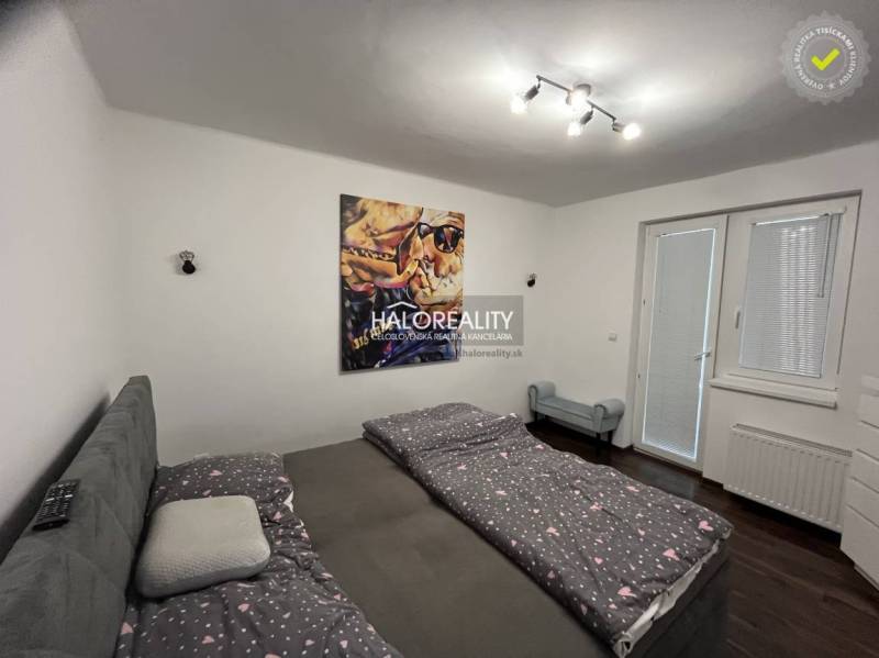 Bedroom with a bed and a painting, access to the garden through the window, Family house.