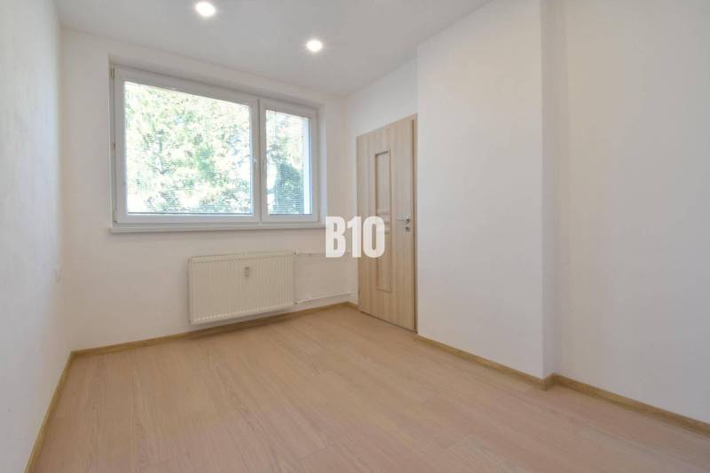 A bright room with a window and a radiator in a 3-room apartment.