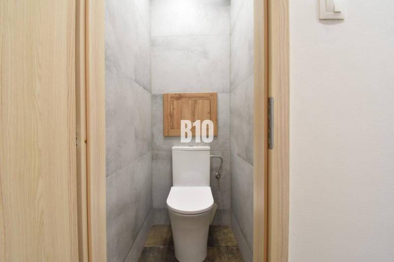 A toilet with a simple design in a 3-room apartment.