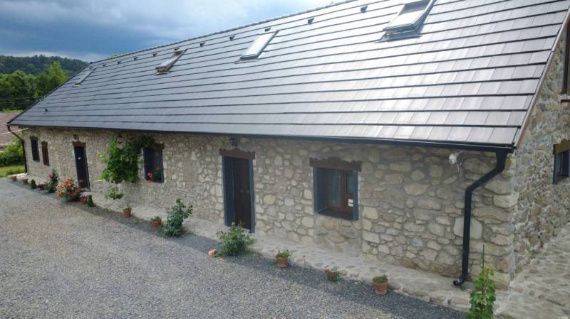 Stone family house in BOLDOGKOVARALJA with windows and a sloped roof.